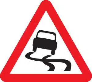 slippery road ahead road sign
