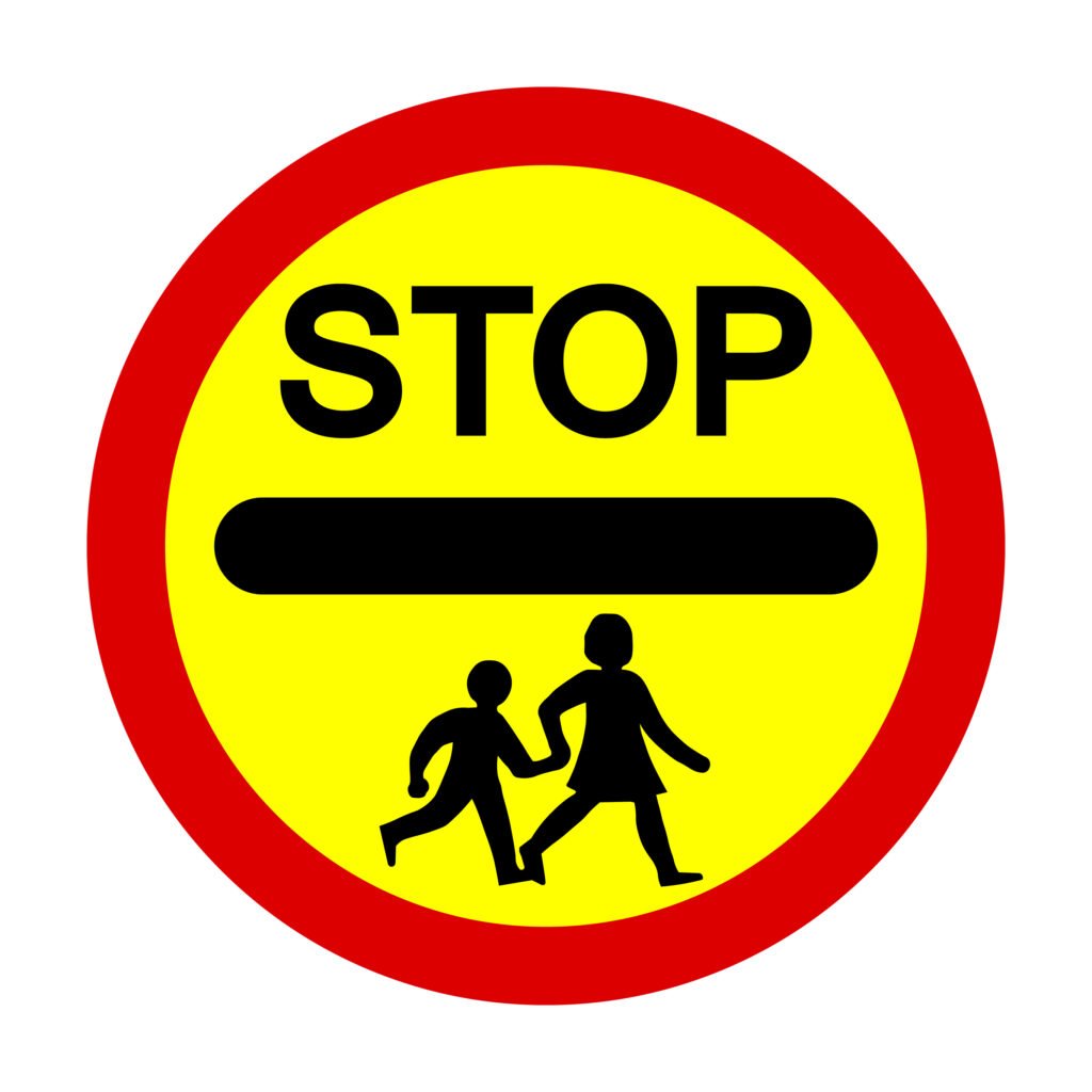 School Crossing Patrol Signs and How They’re Used If you’ve ever walked or driven past a school at pick-up or drop-off time, you’ll know how busy and hectic it can get. To keep children safe, the law gives extra powers to School Crossing Patrols — often called “lollipop men” or “lollipop ladies” — who use a very distinctive sign. Let’s break down exactly what the sign means, how it’s used, and what drivers need to do. What the Sign Looks Like The School Crossing Patrol sign is hard to miss: A large, round sign on a stick, with a red border, yellow background, and the word “STOP” in black. A black horizontal line runs through the middle, with silhouettes of children walking underneath. It’s often called the “lollipop sign” because of its shape. By law, this sign gives the patrol officer the authority to stop traffic so that children and parents can cross safely. When It’s Used School Crossing Patrols usually operate: Before and after school hours when children are arriving or leaving. Near school entrances, busy junctions, or pedestrian routes that see heavy use. In all weathers — from sunny mornings to dark, rainy afternoons — visibility is vital, which is why the sign is so bold and reflective. What Drivers Must Do When a patrol officer steps into the road and raises the sign: You must stop — it’s a legal requirement. Wait patiently while children and parents cross. Do not move off until the patrol has stepped back onto the pavement and lowered the sign. Failing to stop for a School Crossing Patrol is not just dangerous — it’s an offence that can lead to fines, points on your licence, and even prosecution. Why It Matters The presence of a School Crossing Patrol is about safety first. Children can be unpredictable near roads, and traffic around schools can get chaotic. The sign provides a clear, respected command for drivers, giving children the confidence to cross safely. Key Points for Learner Drivers Always approach schools with extra caution. Look out for the patrol officer in high-visibility clothing. The “STOP” sign has the same force as a police officer’s signal — you must obey it. Never wave children across yourself — leave that job to the patrol. Final Word The School Crossing Patrol sign is one of the most important on UK roads, not because it’s complicated, but because it protects the most vulnerable. As a driver, treating it with respect shows maturity, patience, and real responsibility behind the wheel.